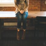 Woman sitting on a bench, photo without face visible